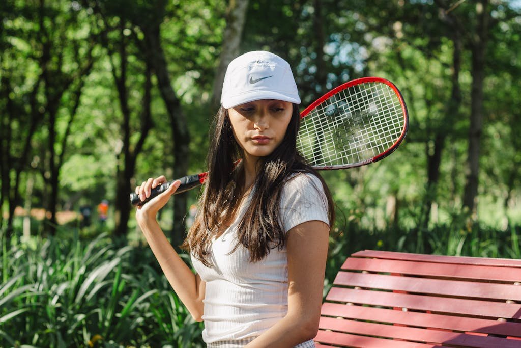 A girl exercising while wearing a hat