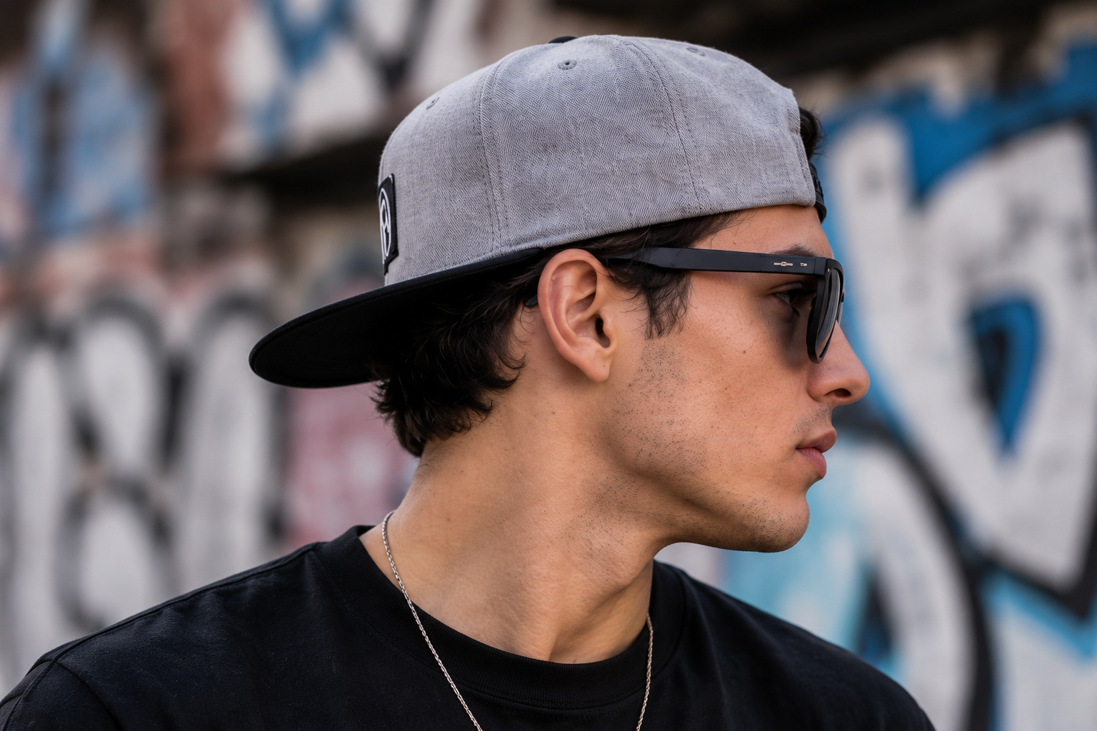 A cool boy wearing a snapback hat backwards